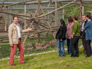 Guide welcomes visitor group